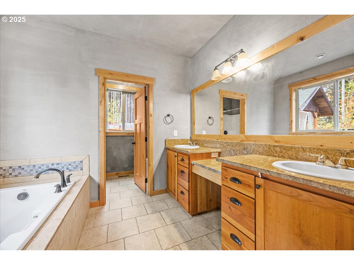 39577 Southeast Kitzmiller Road Eagle Creek, OR 97022 - Photo 8 of 41 a spacious bathroom with a granite countertop sink mirror and a bathtub