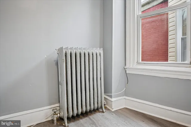 a view of a room with wooden floor and a window