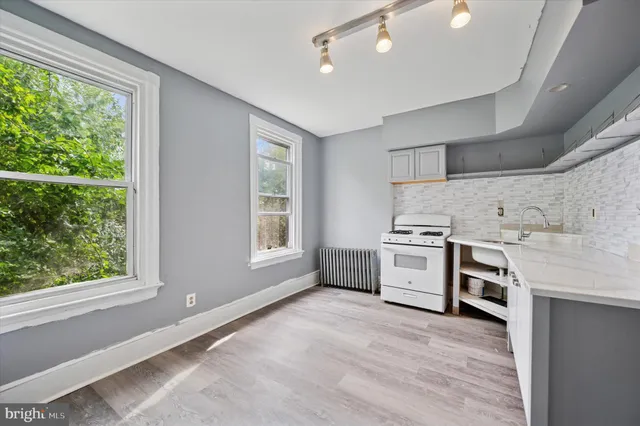 a kitchen with a stove oven and sink