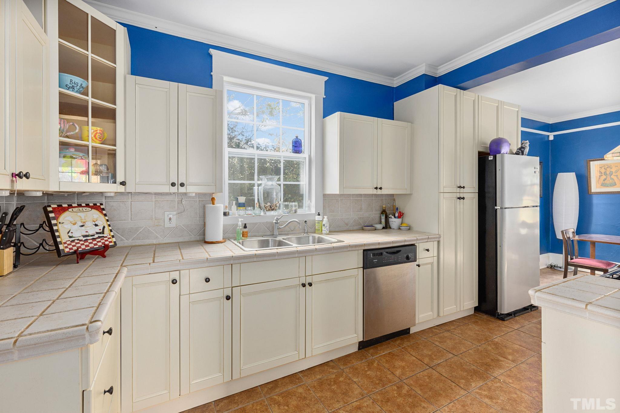 330 Pershing Road Raleigh, NC 27608 - Photo 11 of 51 a kitchen with white cabinets and white appliances