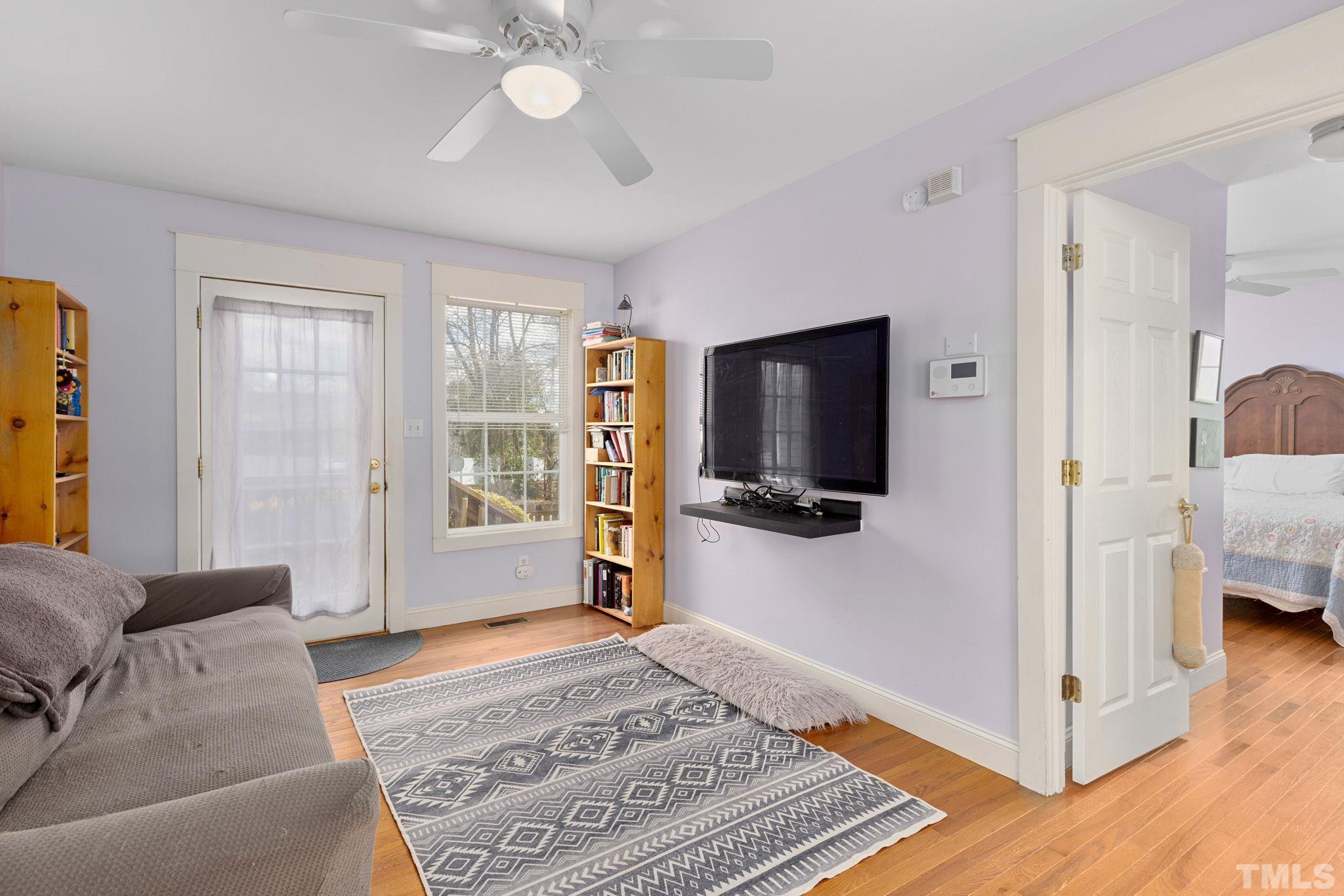 330 Pershing Road Raleigh, NC 27608 - Photo 17 of 51 a living room with a flat screen tv and a chandelier