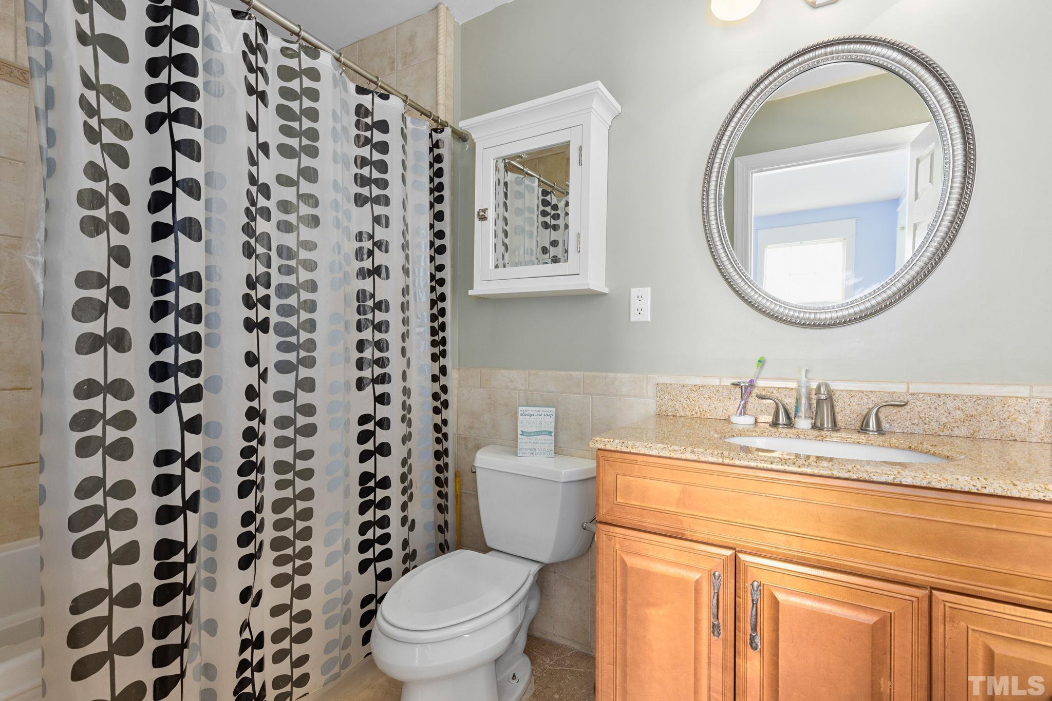 330 Pershing Road Raleigh, NC 27608 - Photo 21 of 51 a bathroom with a granite countertop sink and a mirror