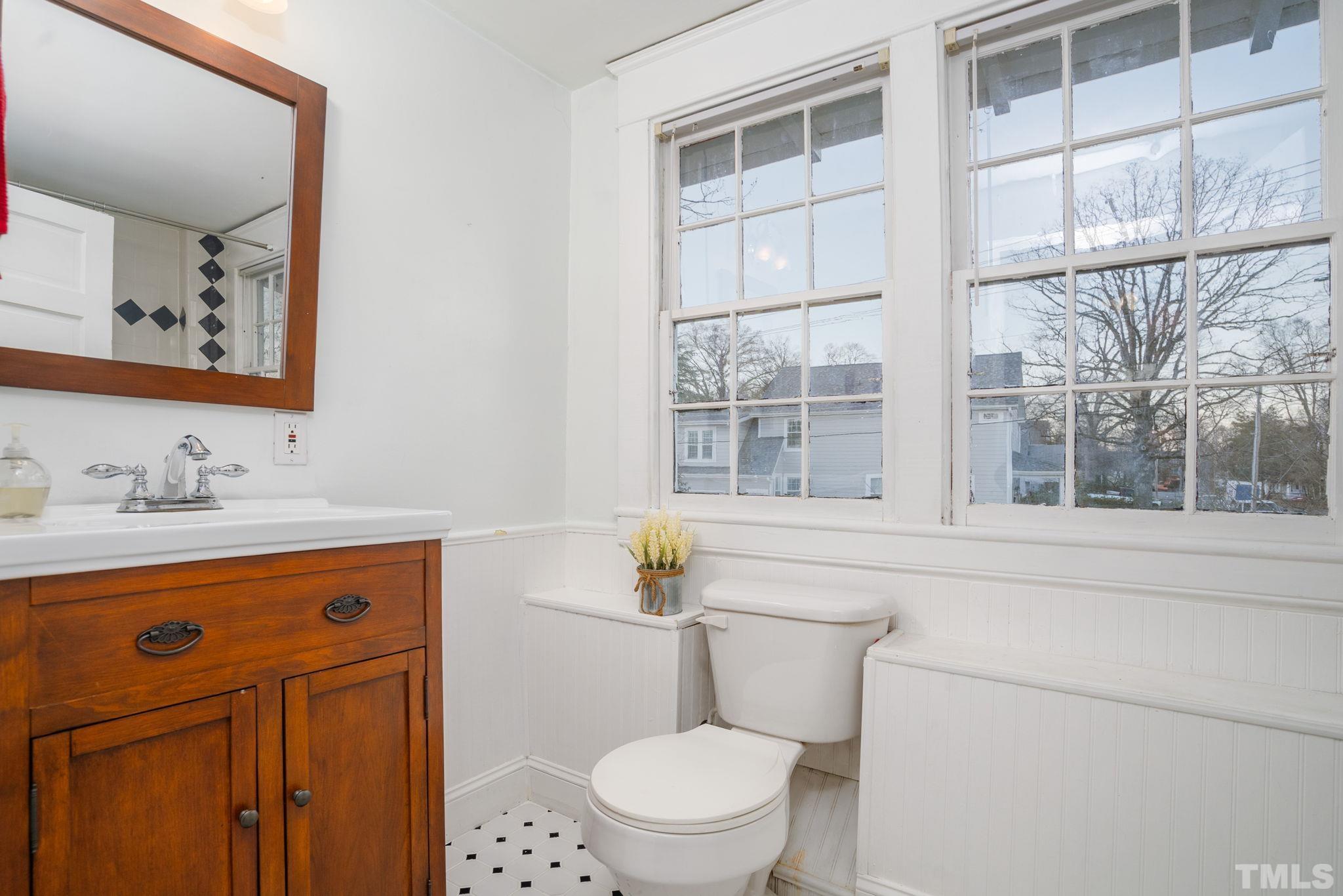 330 Pershing Road Raleigh, NC 27608 - Photo 27 of 51 a bathroom with a sink a toilet and a window