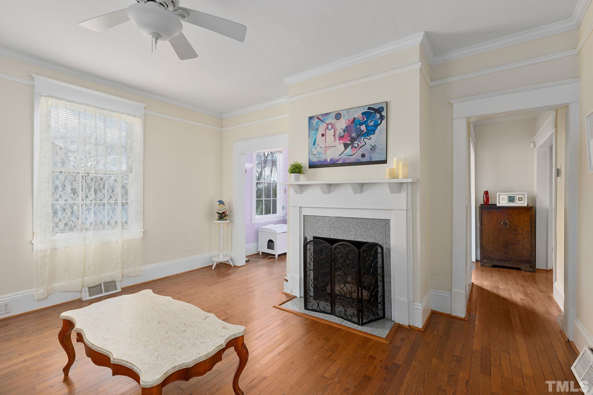 330 Pershing Road Raleigh, NC 27608 - Photo 4 of 51 a living room with furniture and a fireplace