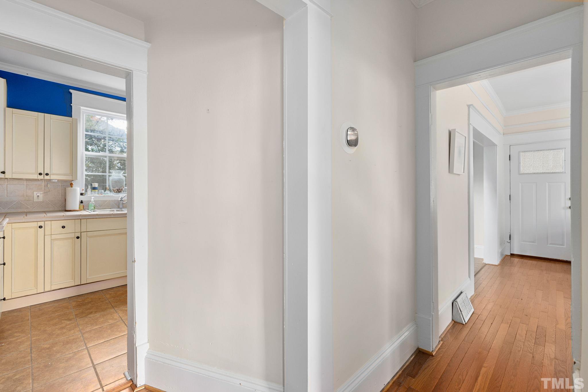 330 Pershing Road Raleigh, NC 27608 - Photo 10 of 51 a view of a kitchen with white cabinets and wooden floor
