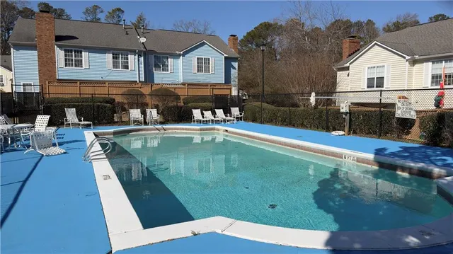 a swimming pool view with a outdoor seating