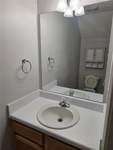 a bathroom with a sink vanity and a mirror