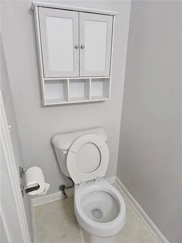 a white toilet sitting next to a bathroom sink