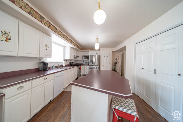 190 600 North Ferron, UT 84523 - Photo 10 of 85 Kitchen with appliances with stainless steel finishes, dark countertops, a center island, and dark wood floors