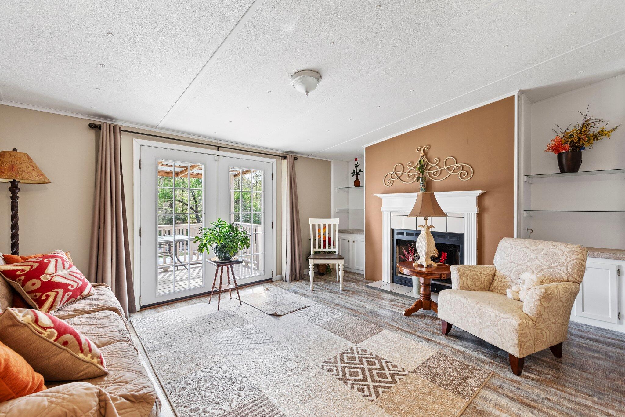 3062 Highland Avenue Crestview, FL 32539 - Photo 12 of 58 a living room with furniture and a fireplace