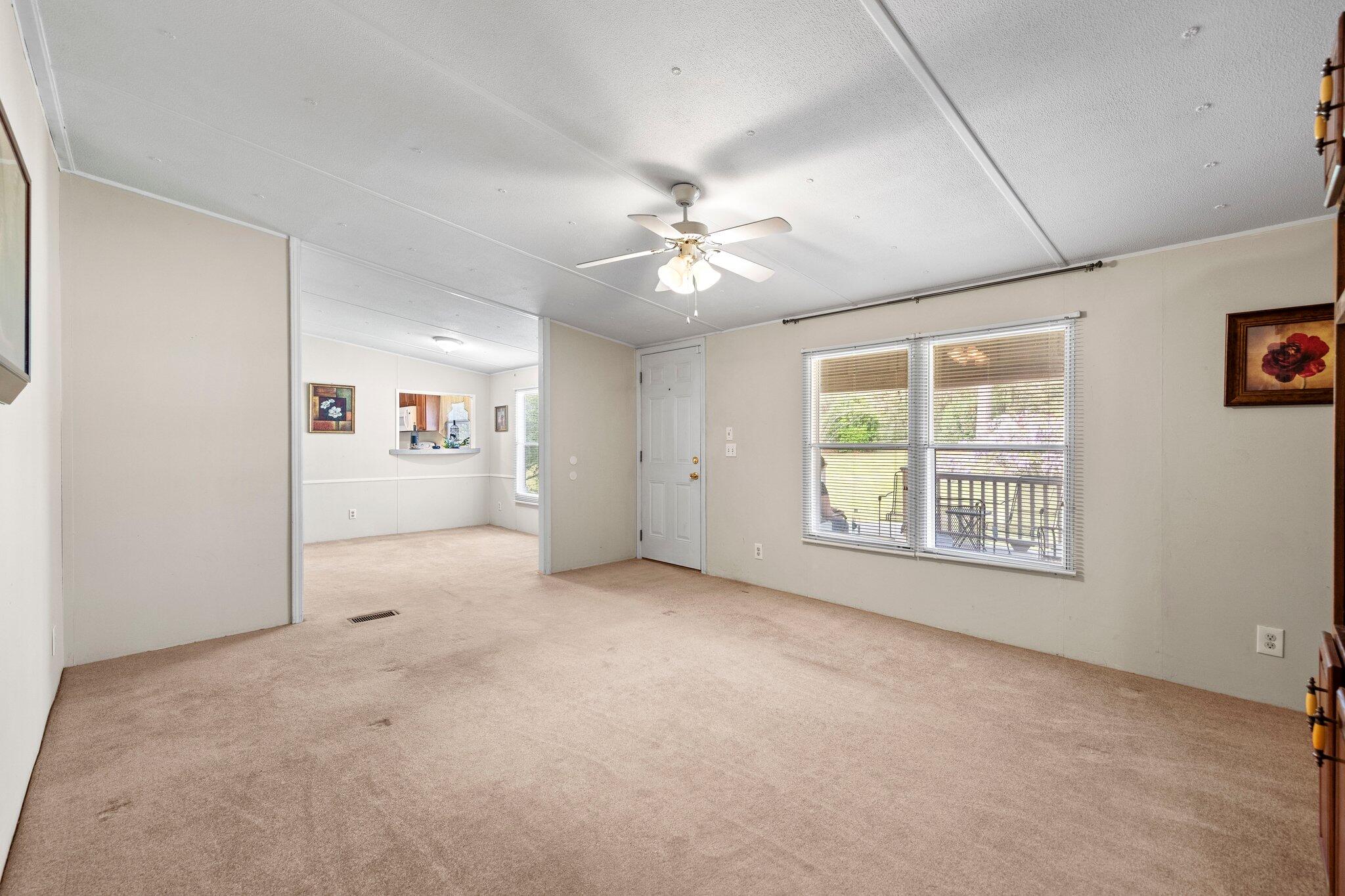 3062 Highland Avenue Crestview, FL 32539 - Photo 13 of 58 an empty room with chandelier fan and windows