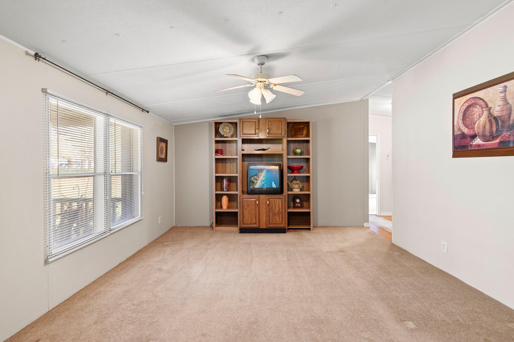 3062 Highland Avenue Crestview, FL 32539 - Photo 16 of 58 an empty room with windows and ceiling fan