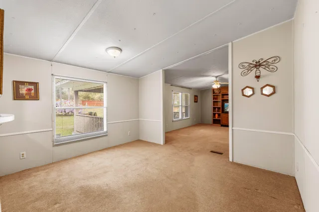 an empty room with windows and closet