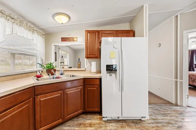 a kitchen with a refrigerator and a sink