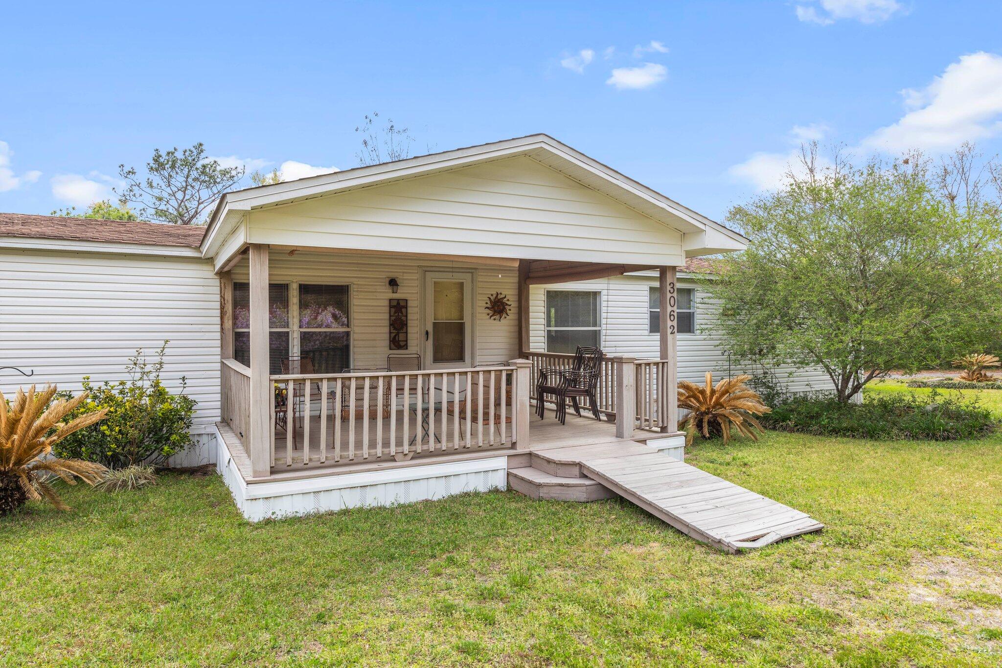 3062 Highland Avenue Crestview, FL 32539 - Photo 2 of 58 a view of a house with a yard and deck