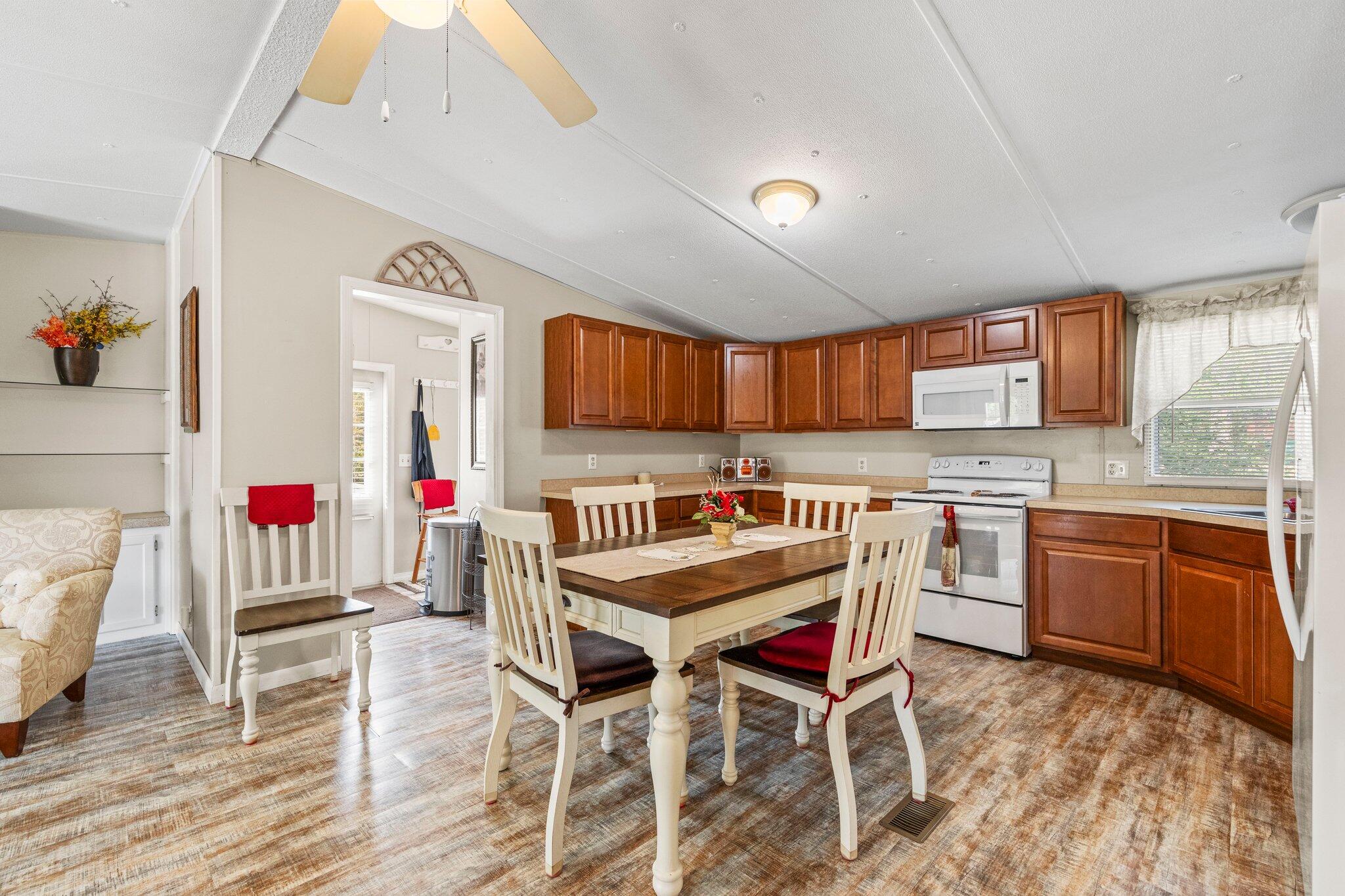 3062 Highland Avenue Crestview, FL 32539 - Photo 21 of 58 a kitchen with granite countertop a dining table chairs sink and cabinets