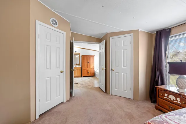 a spacious bedroom with a bed and a chandelier