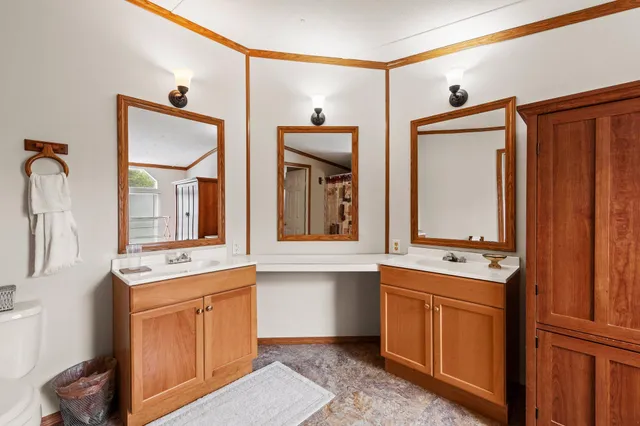 a large bathroom with a tub sink and mirror