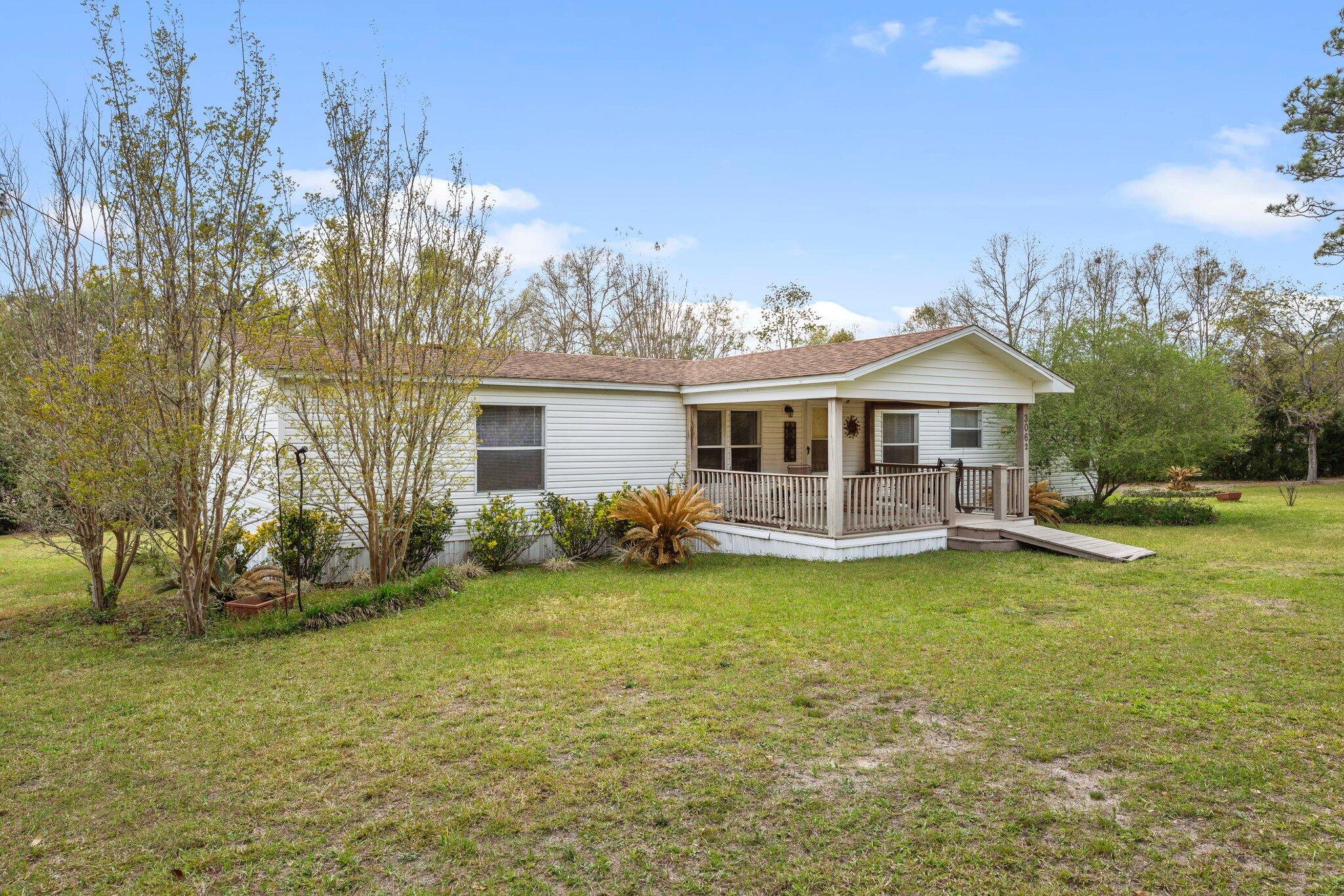 3062 Highland Avenue Crestview, FL 32539 - Photo 3 of 58 a view of a house with a yard and sitting area