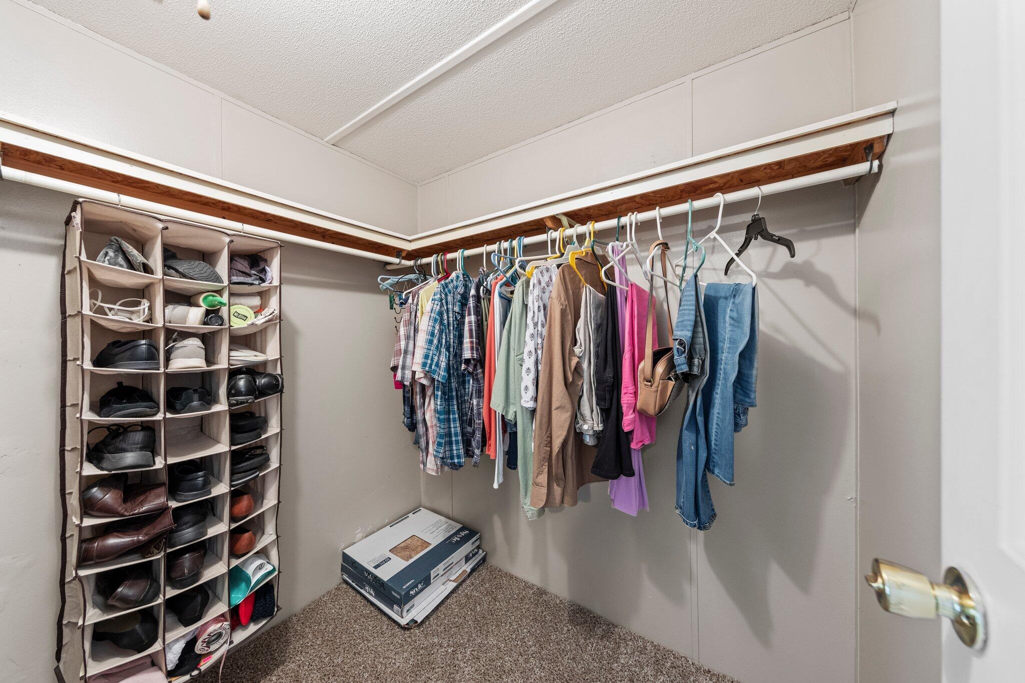 3062 Highland Avenue Crestview, FL 32539 - Photo 32 of 58 a view of walk in closet with clothes and shoes