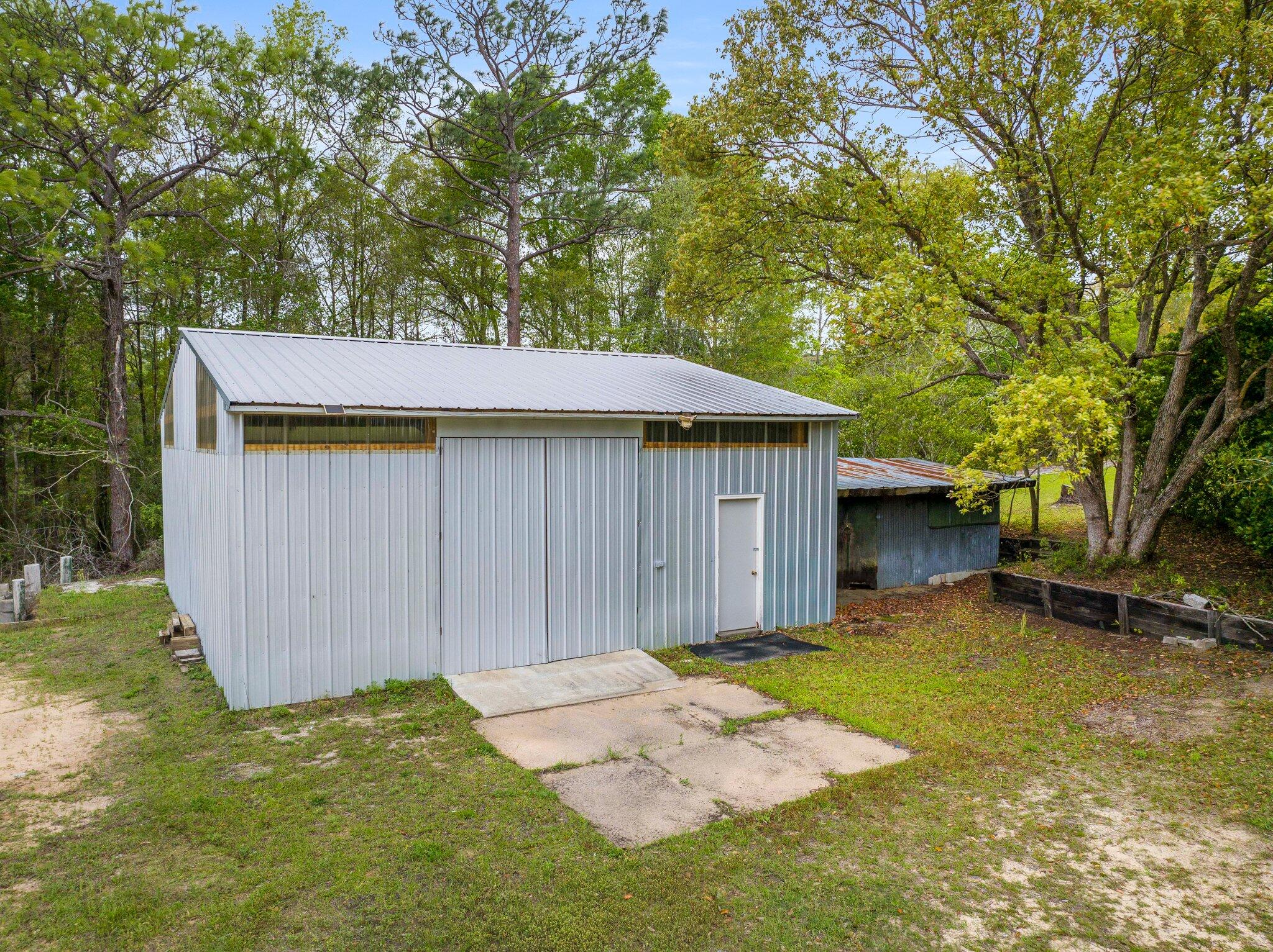 3062 Highland Avenue Crestview, FL 32539 - Photo 41 of 58 a backyard of a house with yard and trampoline