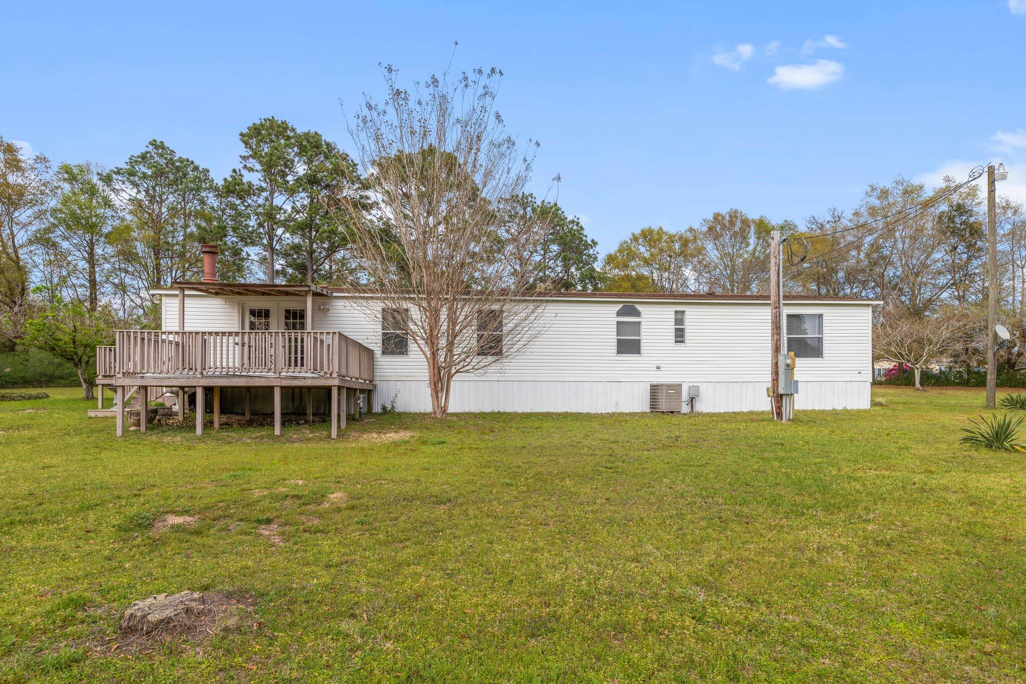 3062 Highland Avenue Crestview, FL 32539 - Photo 5 of 58 a view of a house with a yard and sitting area