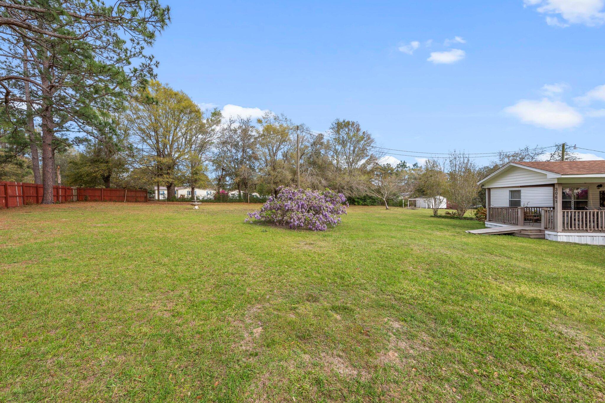 3062 Highland Avenue Crestview, FL 32539 - Photo 7 of 58 a front view of a house with garden