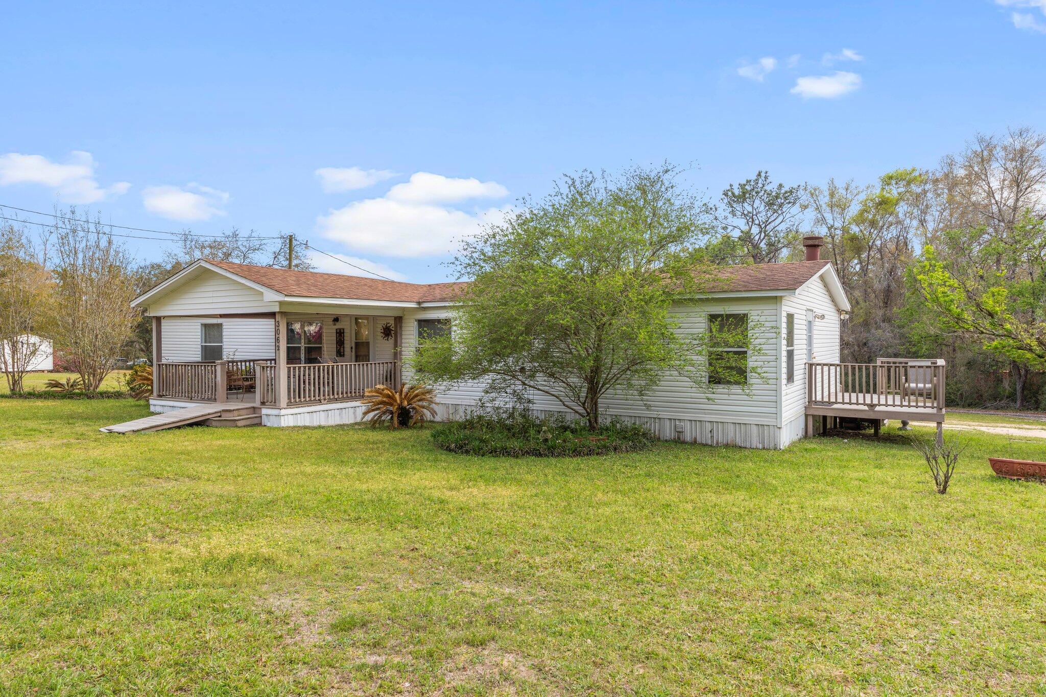 3062 Highland Avenue Crestview, FL 32539 - Photo 9 of 58 a swimming pool with outdoor seating and yard