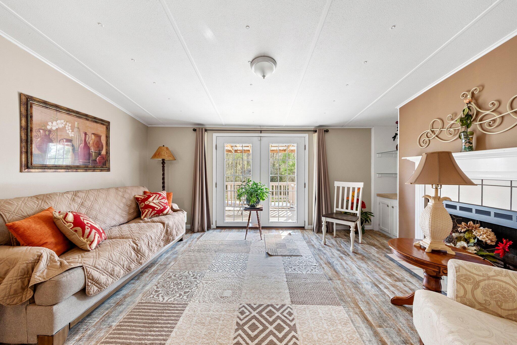 3062 Highland Avenue Crestview, FL 32539 - Photo 10 of 58 a living room with furniture a flat screen tv and a large window