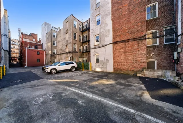 a cars parked in front of brick building