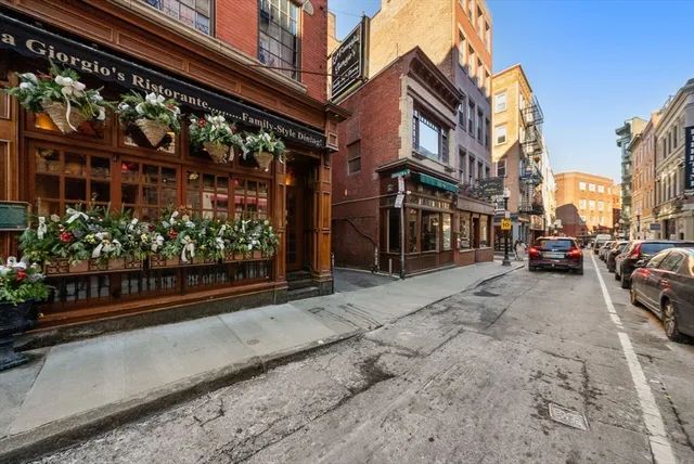 a view of a building with a couple of cars parked in front of a house