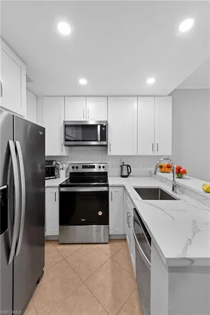 a kitchen with stainless steel appliances and a sink