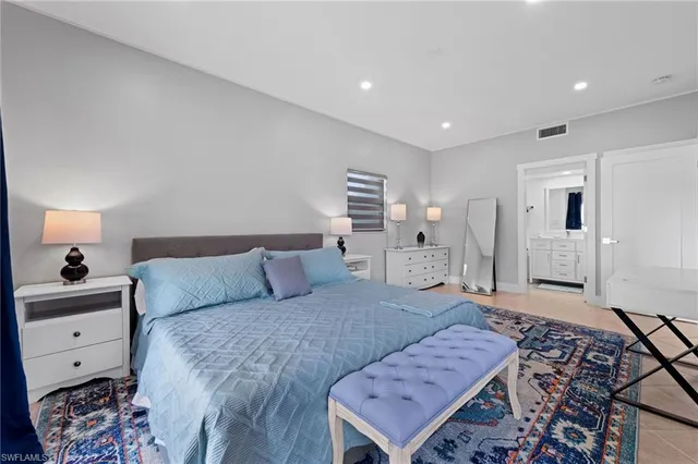 a bed room with a bed and a television