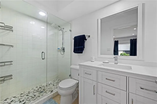 a bedroom with two beds and a large window