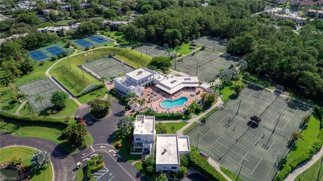 an aerial view of a house with swimming pool patio and lake view