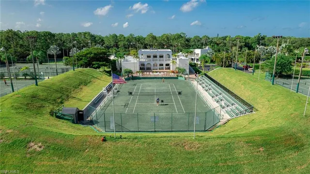 swimming pool view with a garden and large trees