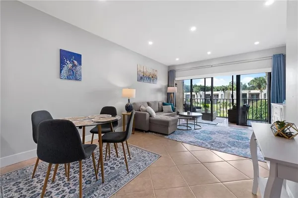 a living room with furniture and large windows