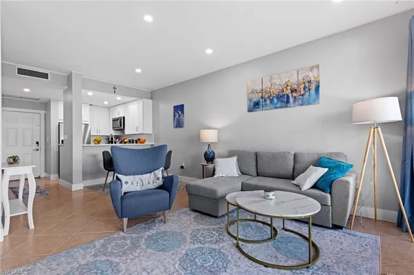 a living room with furniture a rug and a table