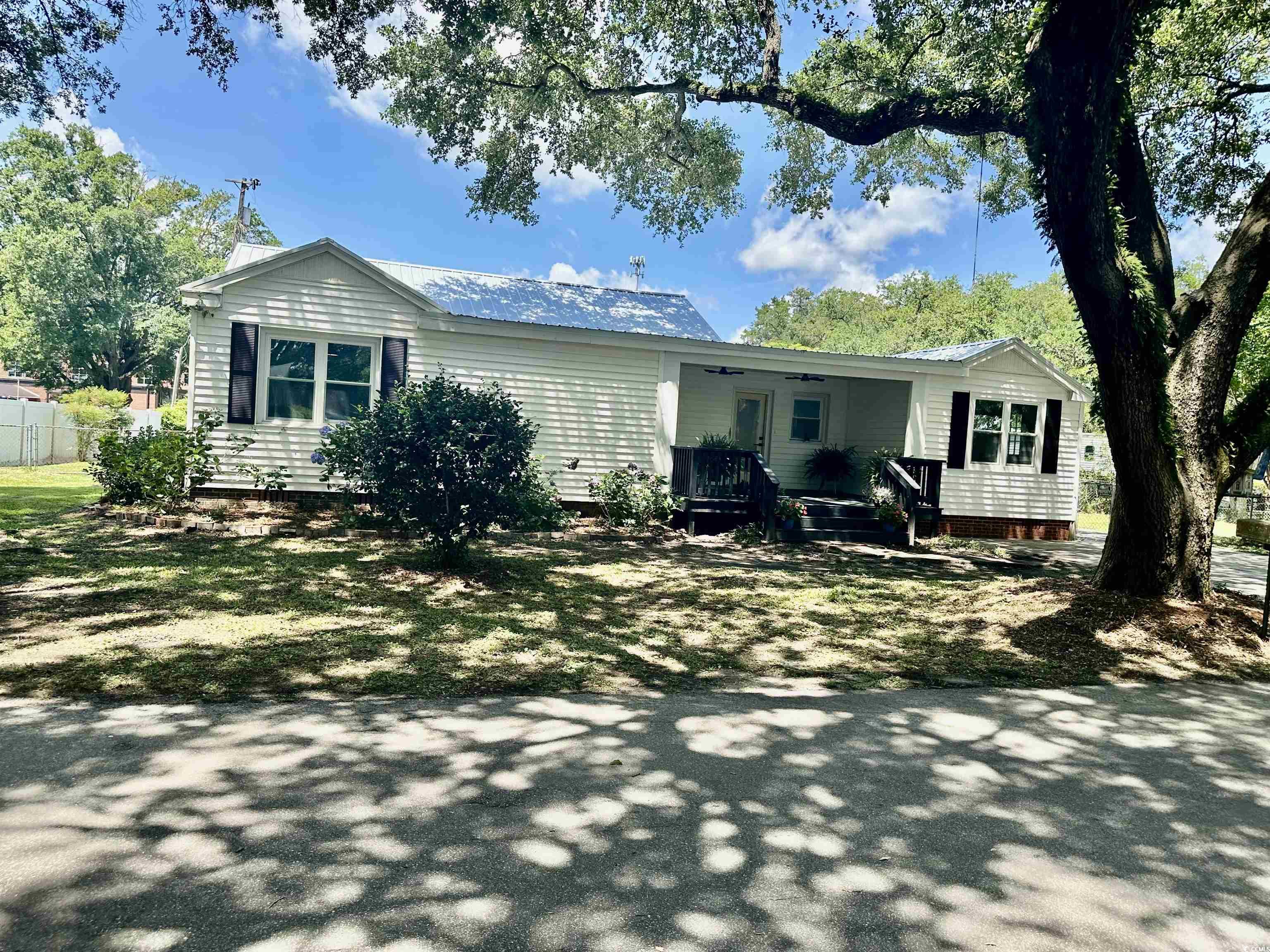 518 Nowell Street Georgetown, SC 29440 - Photo 2 of 28 Back of house featuring a porch, a metal roof, bea