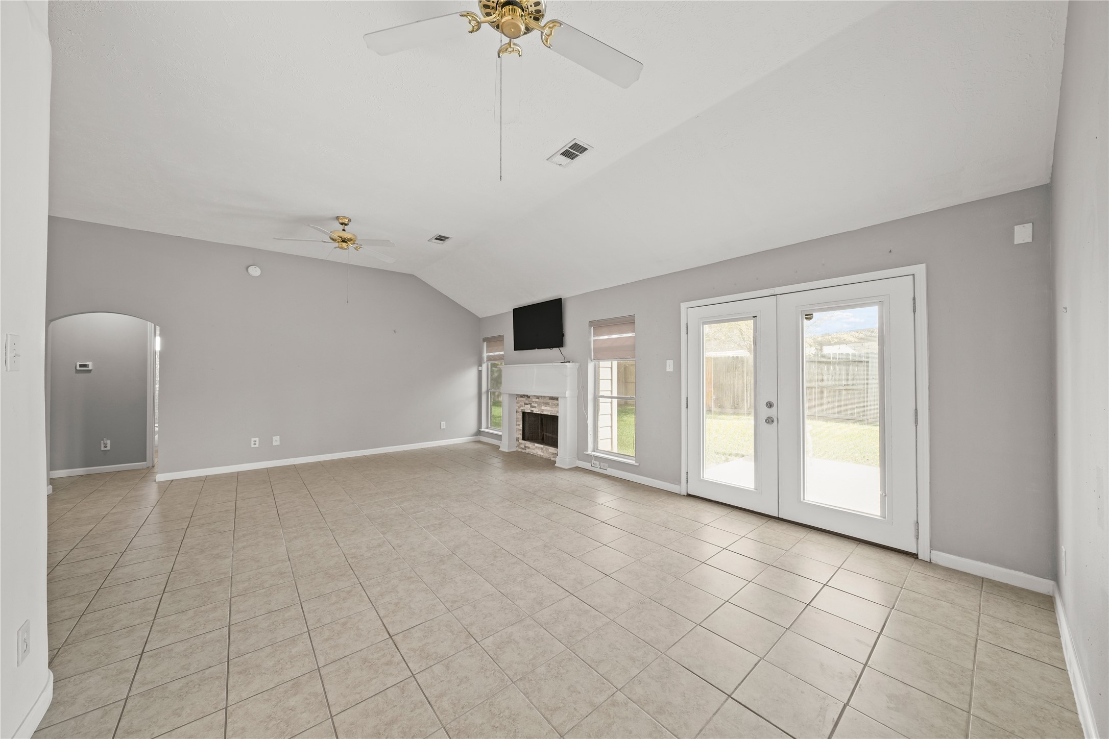 8134 Blue Jay Street Baytown, TX 77523 - Photo 11 of 31 Expansive living spaces are complemented by an abundance of natural light, creating a bright and airy ambiance throughout the home. Oversized windows frame serene views of the backyard, enhancing the seamless flow between indoor comfort and outdoor living.