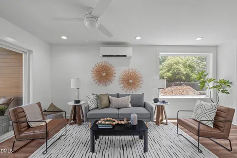 a living room with furniture and a wooden floor