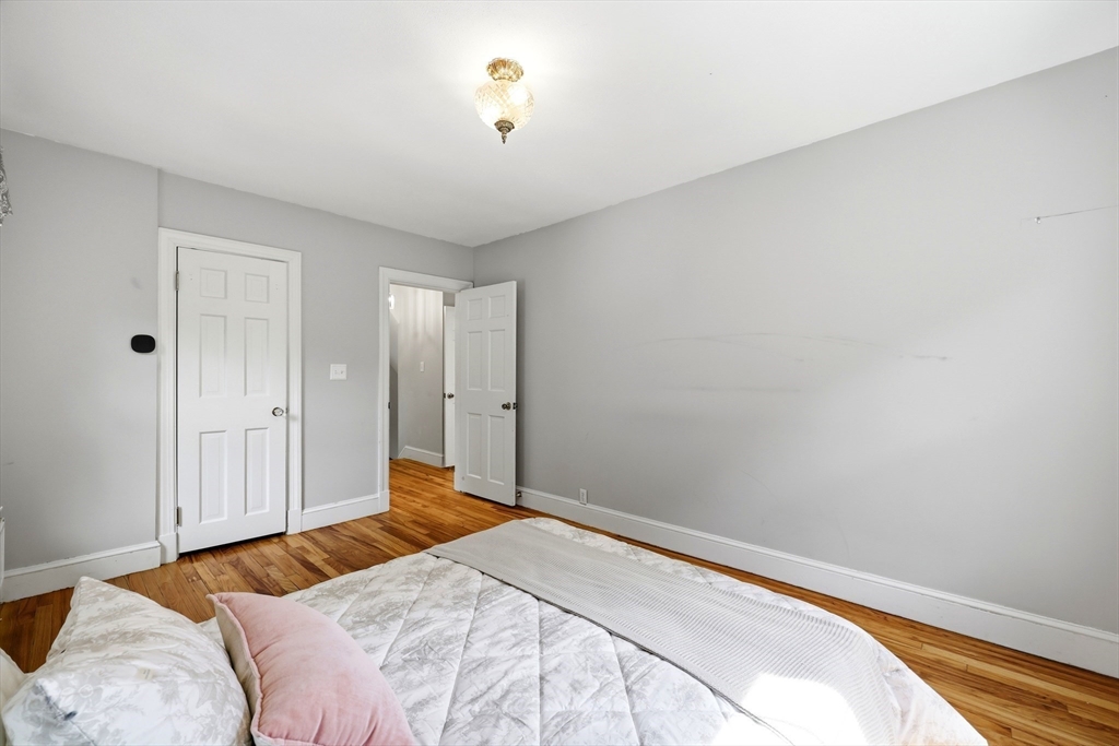 32 Lincoln Road Longmeadow, MA 01106 - Photo 22 of 36 a bedroom with a bed and a chandelier