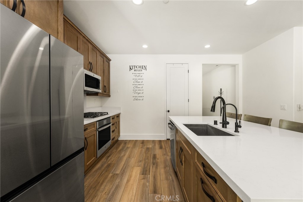 11786 Glenridge Road Corona, CA 92883 - Photo 11 of 73 a kitchen with kitchen island a sink stove and refrigerator