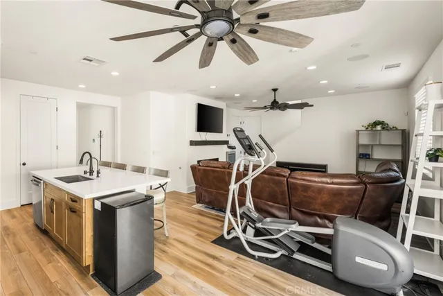 a living room with furniture a ceiling fan and a rug