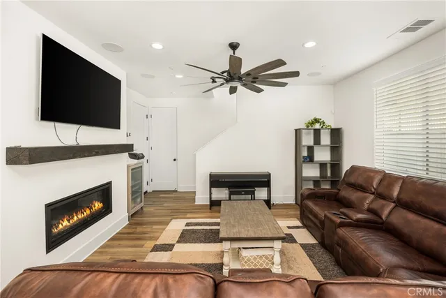 a living room with furniture and a view of kitchen