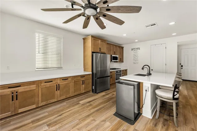 a living room with furniture a ceiling fan and a rug