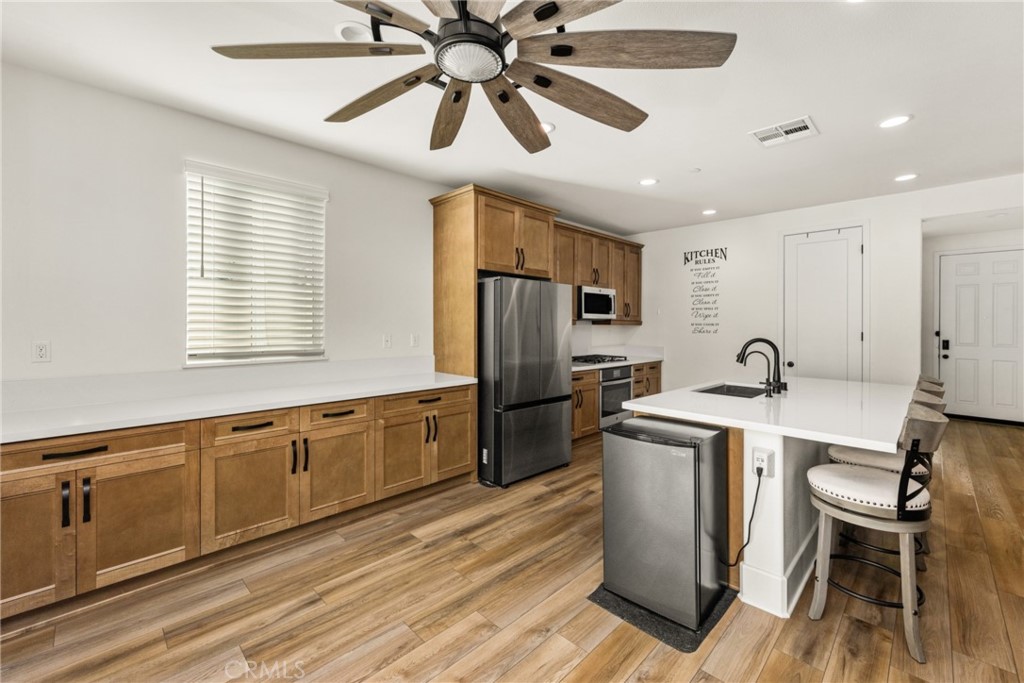 11786 Glenridge Road Corona, CA 92883 - Photo 13 of 73 a kitchen with stainless steel appliances granite countertop a sink a stove and a refrigerator