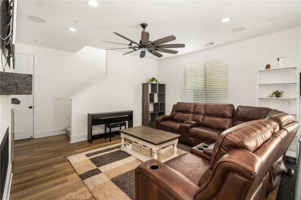 11786 Glenridge Road Corona, CA 92883 - Photo 14 of 73 a living room with furniture a ceiling fan and a rug