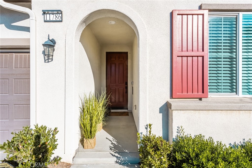 11786 Glenridge Road Corona, CA 92883 - Photo 17 of 73 a vase with flowers sitting on a floor in front of a door