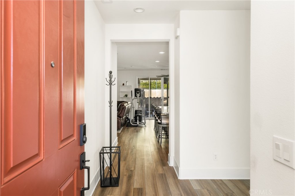 11786 Glenridge Road Corona, CA 92883 - Photo 18 of 73 a view of a hallway with wooden floor fireplace and living room